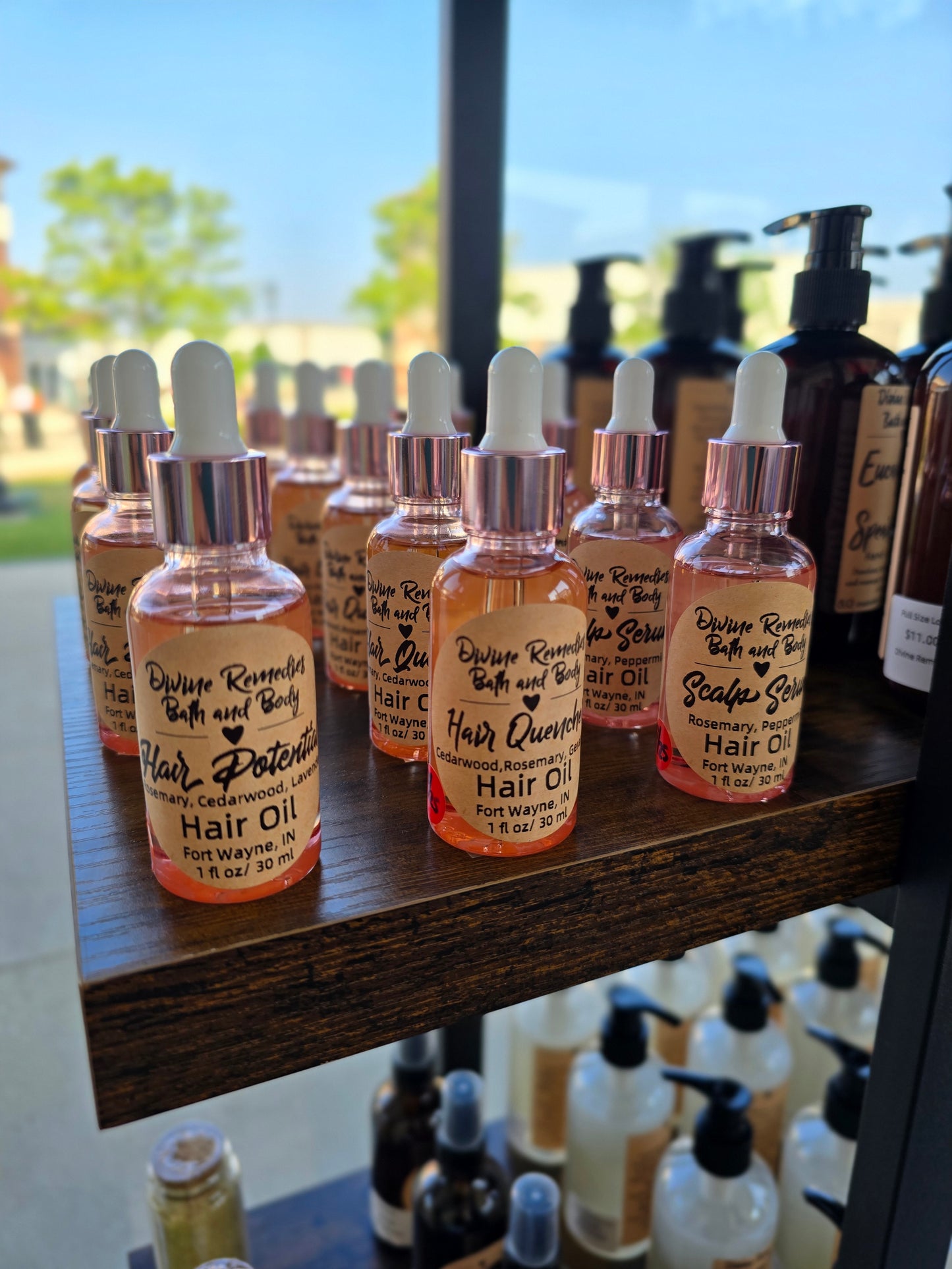 Row of small bottles with droppers on a wooden shelf.