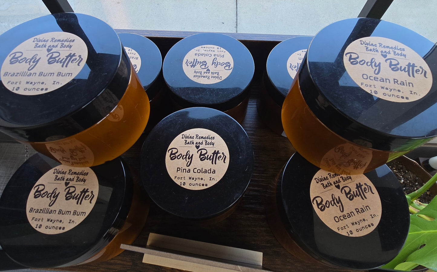 Set of colorful hair dye containers with labels on a wooden stand.