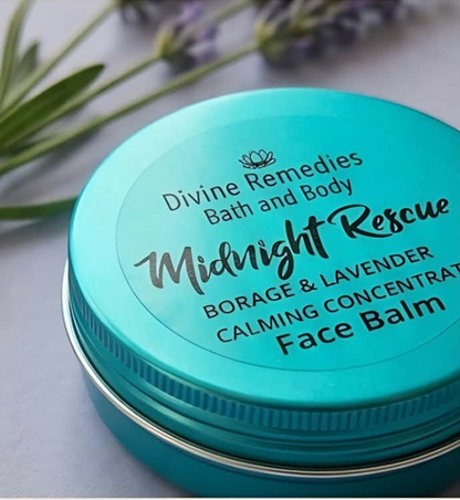 A round turquoise metal tin of Divine Remedies Bath and Body Midnight Rescue Borage & Lavender Calming Concentrate Face Balm, shown with blurred lavender sprigs on a light surface.