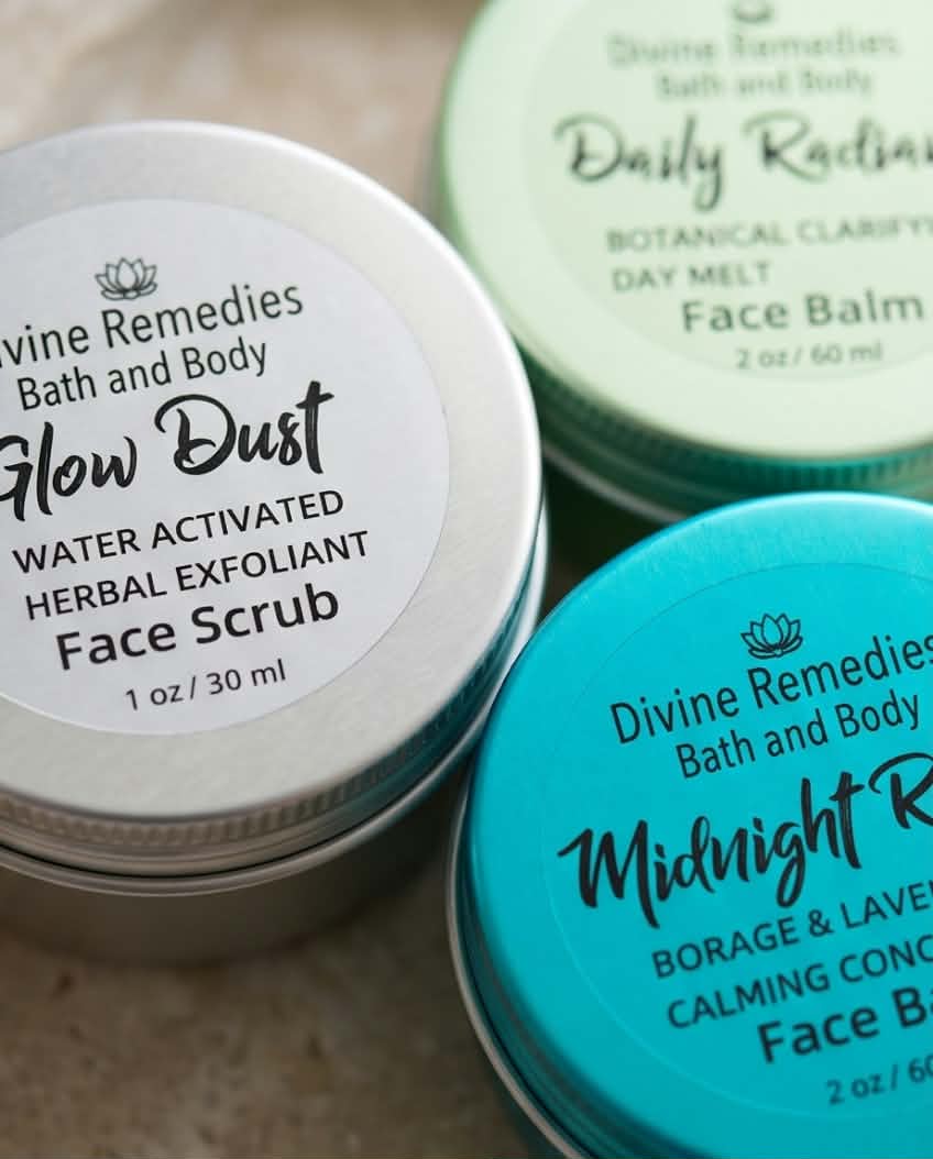 Close-up of Glow Dust, Midnight Rescue, and Daily Radiance skincare tins by Divine Remedies.
