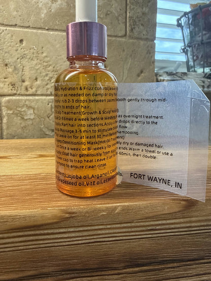 Divine Remedies Nectar of the Crown hair oil bottle on a wooden surface